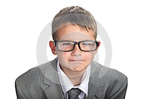 Portrait of a serious child dressed in a business suit and glasses as a businessman. Face of smart boy in glasses and adult suit photo