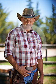 Portrait, serious cowboy and man at farm in the rural countryside for agriculture in Texas. Ranch, confidence and male