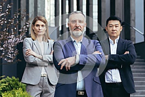 Portrait of serious diverse business team, employees with boss together looking at camera