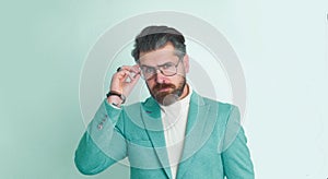 Portrait of serious fashionable handsome man in blue suit.