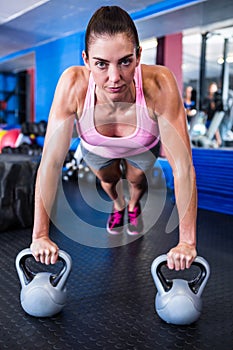 Portrait of serious female athlete doing push-ups