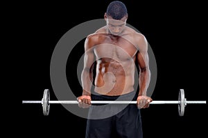 Portrait of a serious fit young man lifting barbell