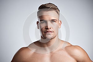 Portrait, serious fitness and strong man on studio, background and backdrop for power, athletic confidence and athlete