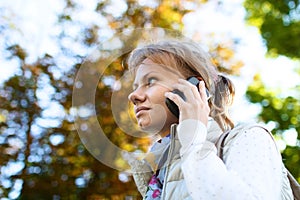 Portrait of serious focused girl speaking by phone