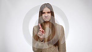 Portrait of serious girl shaking hand and showing no or denial gesture with hand