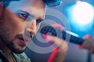 Portrait of a serious, handsome guitarist