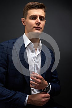 Portrait of serious handsome male in trendy suit, isolated