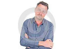 Portrait serious handsome man arms crossed over white background