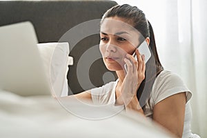 Attentive female telecommuter having a phone conversation photo