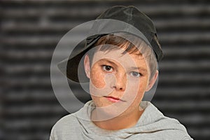 Portrait of a serious looking teenager boy with freckles