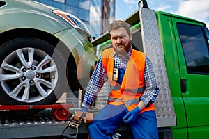 Portrait of serious male tow truck operator