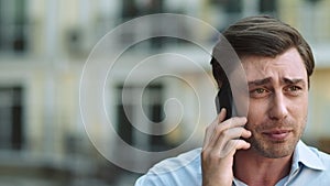 Portrait serious man having phone talk. Angry businessman talking on smartphone