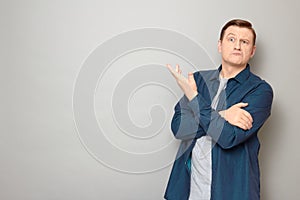 Portrait of serious man thinking hard and actively gesturing with hand