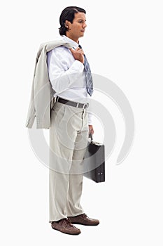 Portrait of a serious office worker holding his jacket over his