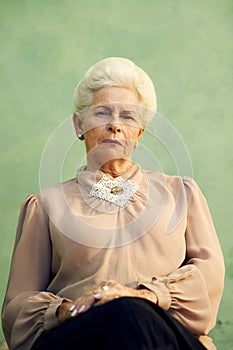 Portrait of serious old caucasian woman looking at camera