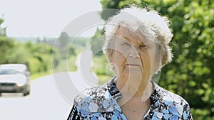 Portrait of serious old elderly woman outdoors