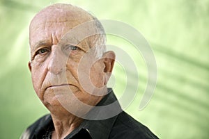 Portrait of serious old hispanic man looking at camera