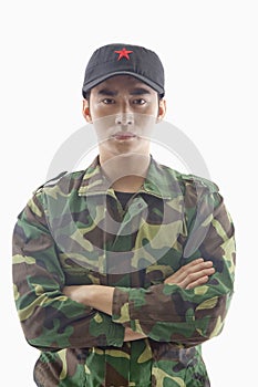 Portrait of Serious Solider With Arms Crossed, Studio Shot, Waist Up