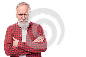 portrait of a serious sullen 60s middle aged mature man in a stylish shirt on a white background with copy space