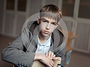 Portrait of serious teenage boy in class