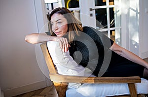 Portrait of a serious thoughtful woman In a cozy living room at home.