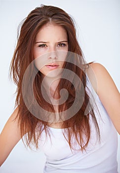 Portrait, serious and woman in studio with attitude, confidence or mindset against a white background. Hair fail, face