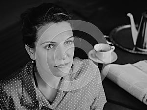 Portrait of a serious woman at tea time looking to the top