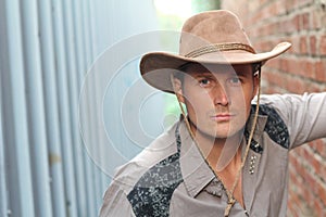 Portrait of serious young attractive cowboy