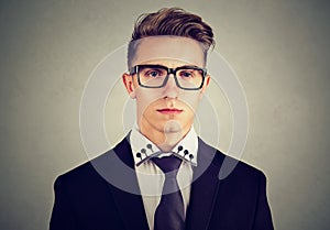 Portrait of a serious young business man on gray background