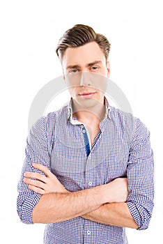 Portrait of serious young businessman posing with crosed hands