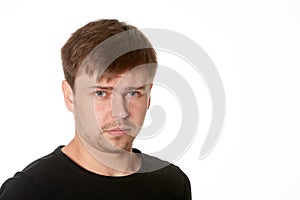 Portrait of serious young man, questioning expression,horizontal on white background with space for text