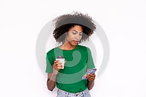 Portrait of serious young woman with coffee reading message