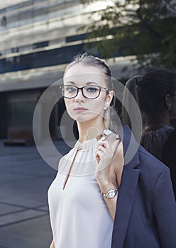 Portrait of serious young woman with glasses