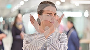 Portrait of Serious Young Woman saying No by Arms Crossed