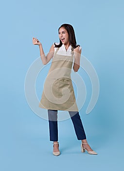 Portrait of service minded asian woman employee studio shot on blue background