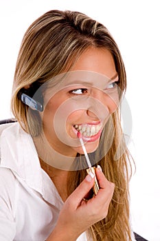 Portrait of service provider applying lipstick