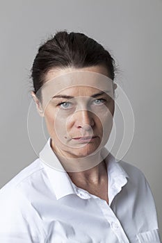 Portrait of severe middle aged woman acting like judge mental
