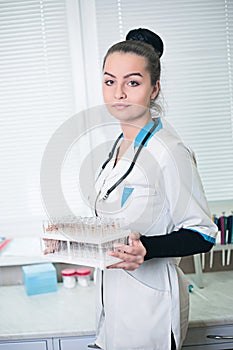 A portrait of beautiful midicine nurse doctor in a white go