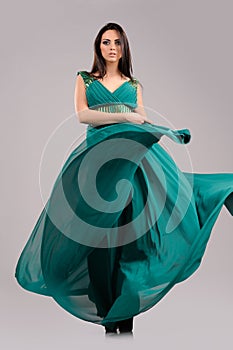 portrait of sexy girl  in green dress on gray background