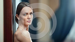 Portrait of sexy naked woman with evening makeup posing in jewellery. Close up shot on 4k RED camera