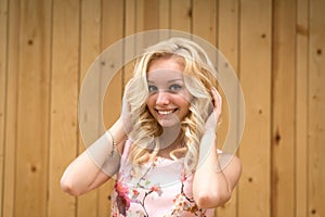 Portrait of a sexy young female blonde on a background of wooden boards