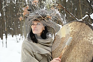 Portrait of a shaman woman in a winter forest