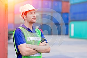 Portrait of shipping worker man proud of work in cargo port for import export goods standing smile