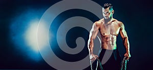 Portrait of shirtless bodybuilder. Muscular man posing in studio.