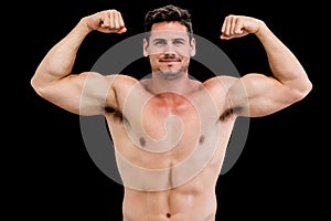 Portrait of shirtless muscular man flexing muscles