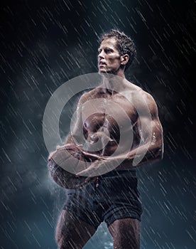 Portrait of shirtless wet bascetball player.