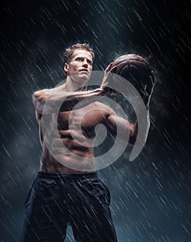 Portrait of shirtless wet bascetball player.