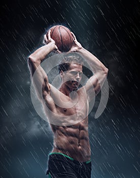 Portrait of shirtless wet bascetball player.