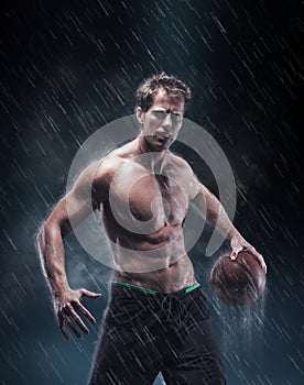 Portrait of shirtless wet bascetball player.