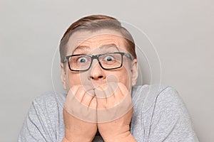Portrait of shocked frightened man panicking and biting nails